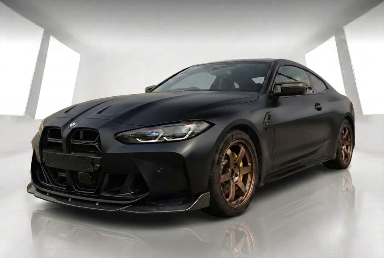 The same BMW M4 after, with matte black wrap, carbon lip and bronze wheels applied with AI